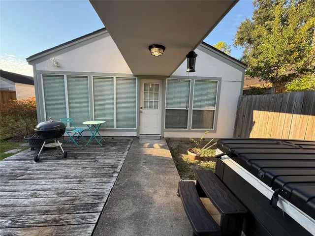 a balcony with chairs and a potted plant