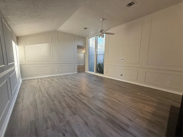 a view of a room with wooden floor