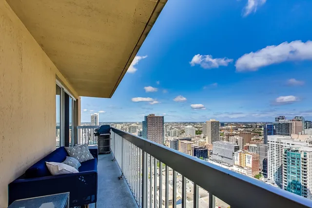 a view of a balcony with couches and wooden floor