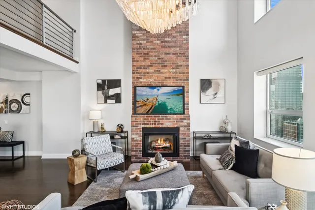 a living room with furniture a fireplace and a flat screen tv