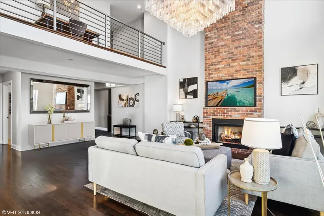 a living room with fireplace furniture and a wooden floor