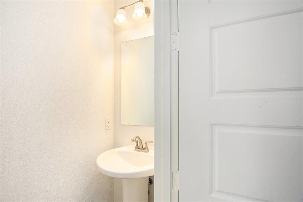 6033 Mango Drive Sanger, TX 76266 - Photo 14 of 29 a bathroom with a sink and a mirror
