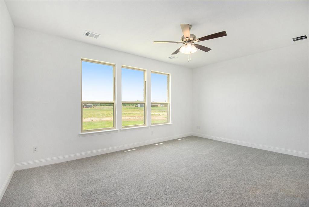 6033 Mango Drive Sanger, TX 76266 - Photo 17 of 29 an empty room with a window and a fan
