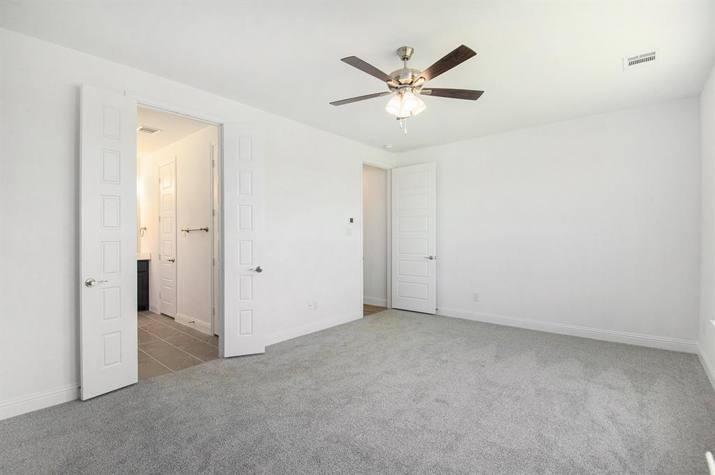 6033 Mango Drive Sanger, TX 76266 - Photo 18 of 29 an empty room with a chandelier fan and a window