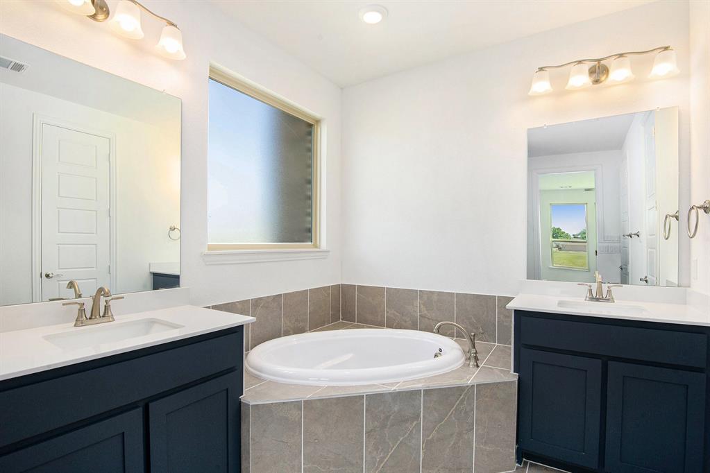 6033 Mango Drive Sanger, TX 76266 - Photo 20 of 29 a bathroom with a sink and a mirror