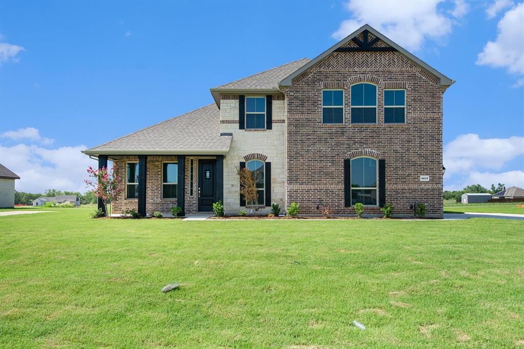 6033 Mango Drive Sanger, TX 76266 - Photo 2 of 29 a front view of a house with garden