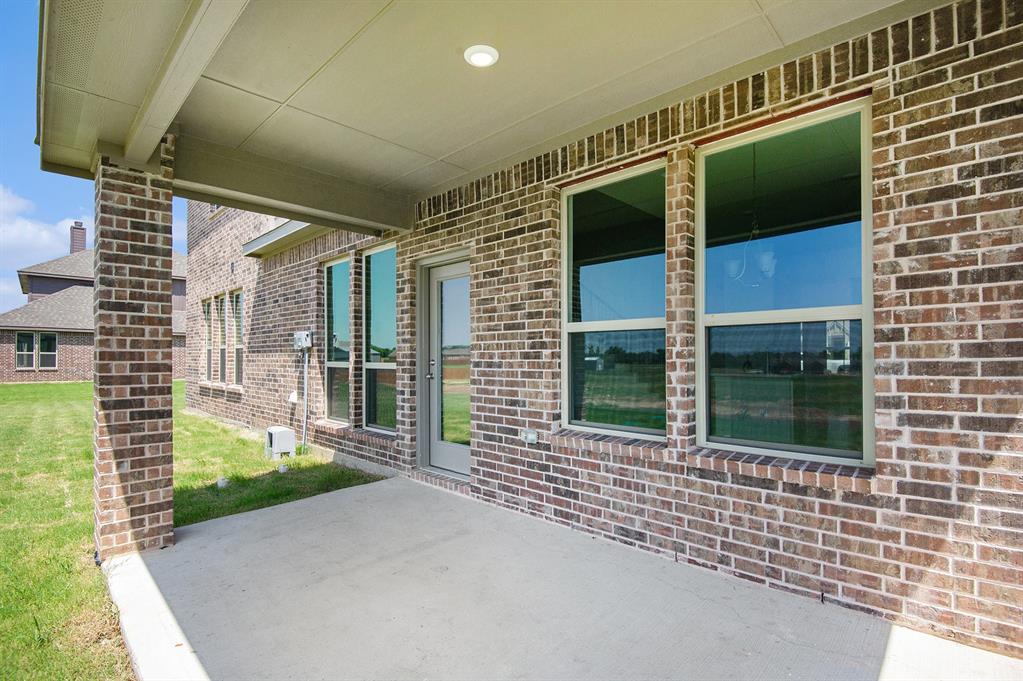 6033 Mango Drive Sanger, TX 76266 - Photo 25 of 29 a front view of a house with a large window