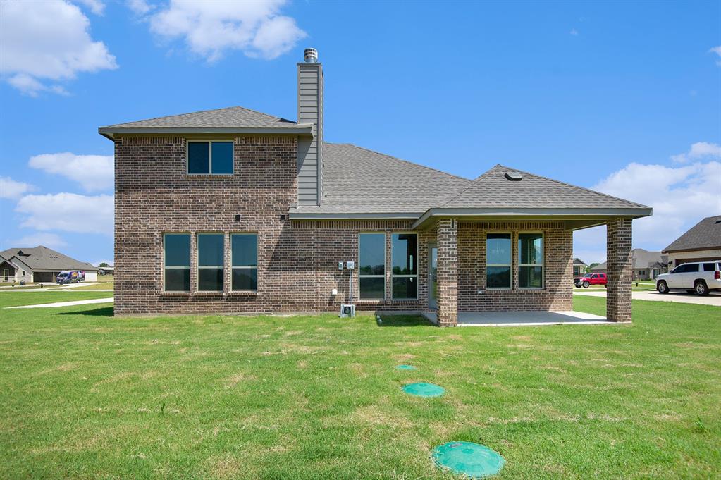 6033 Mango Drive Sanger, TX 76266 - Photo 26 of 29 a view of a house with a yard and sitting area