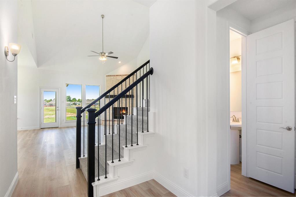 6033 Mango Drive Sanger, TX 76266 - Photo 3 of 29 a view of hallway with stairs and wooden floor