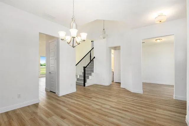 a view of a livingroom with wooden floor and a ceiling fan