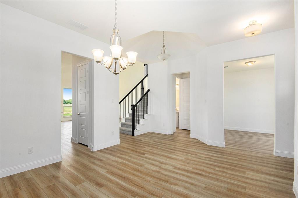 6033 Mango Drive Sanger, TX 76266 - Photo 5 of 29 a view of a livingroom with wooden floor and a ceiling fan