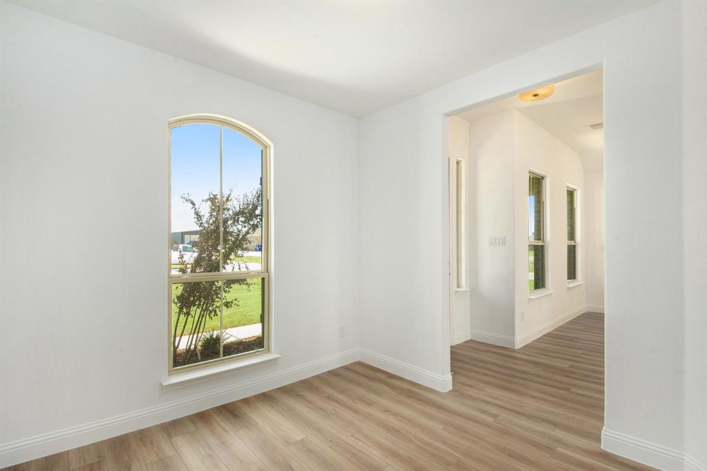 6033 Mango Drive Sanger, TX 76266 - Photo 6 of 29 an empty room with wooden floor and a window