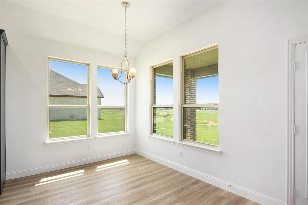 6033 Mango Drive Sanger, TX 76266 - Photo 10 of 29 a view of an empty room with a window and wooden floor