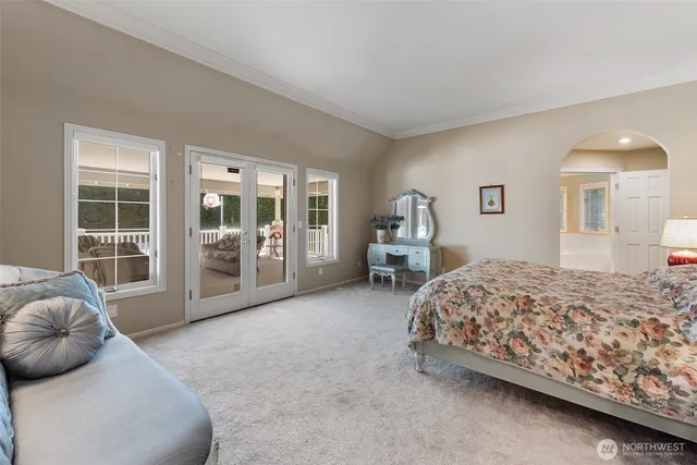 a spacious bathroom with a double vanity sink a bathtub and next to a window