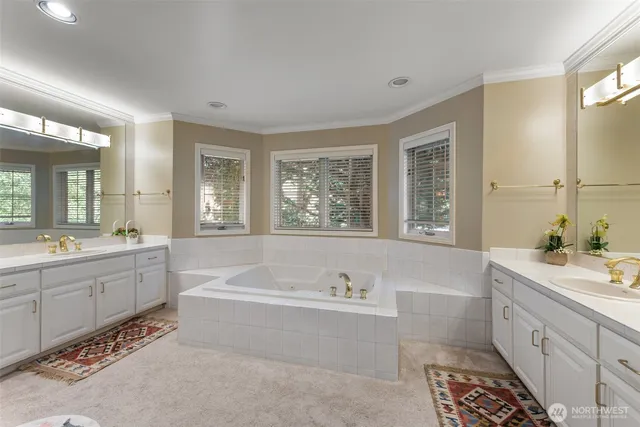 a spacious bathroom with a tub sink and mirror