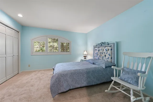 a bedroom with a bed and window