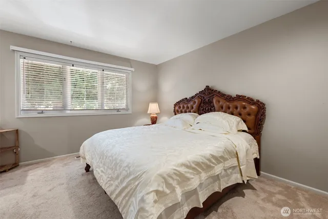 a bedroom with bed and a window