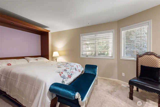 a bathroom with a granite countertop sink a mirror and shower