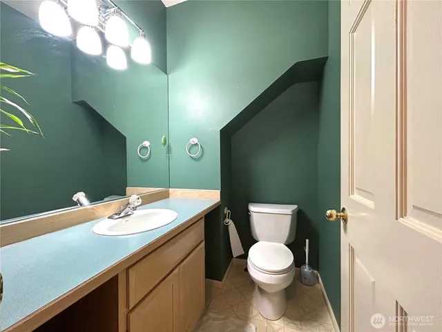 a bathroom with a sink mirror and a shower