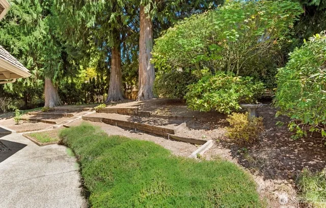 an aerial view of a house with a yard and lake view
