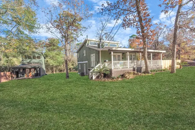 a front view of house with yard and green space