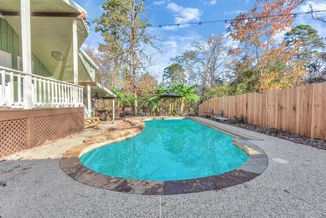 a large white couch sitting in a living room next to a window