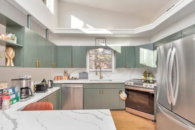 a kitchen with a refrigerator and countertop