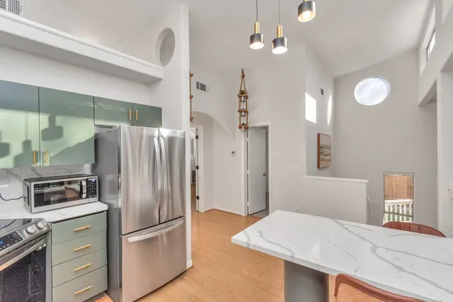 a view of kitchen with sink microwave and refrigerator
