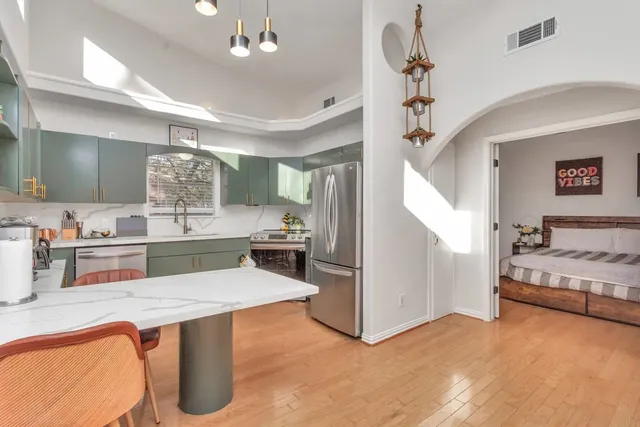 a kitchen with a refrigerator sink and large window