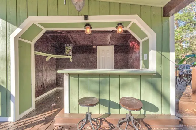 a view of balcony with wooden floor and outdoor seating