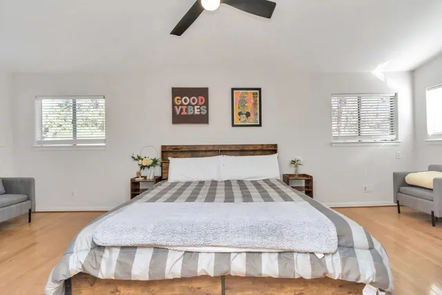 a bedroom with a bed and a chandelier