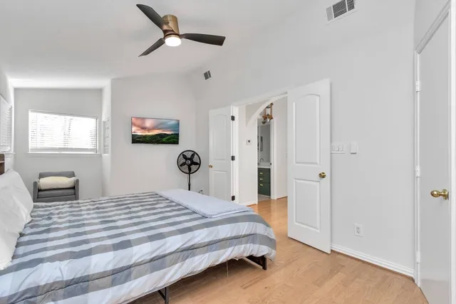 a bedroom with a bed and a window