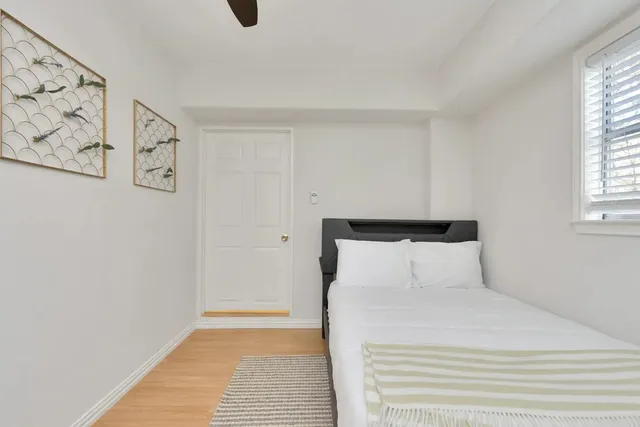 a bedroom with a bed and a window