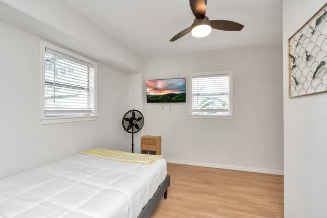 a bedroom with a bed and a window