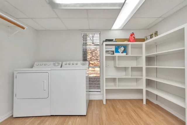 a view of a hallway with wooden floor and entryway