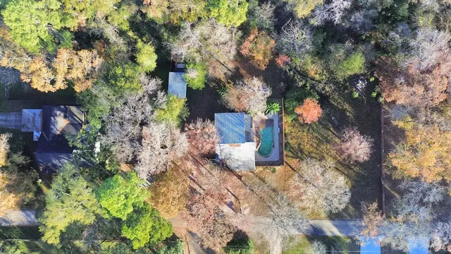 an aerial view of ocean and residential houses with outdoor space