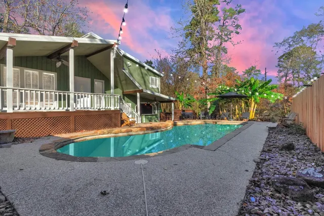 a view of a house with backyard and sitting area