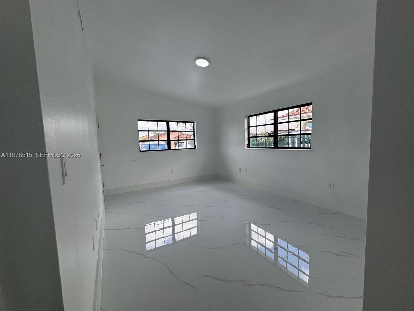 2682 West 70th Place Hialeah, FL 33016 - Photo 12 of 16 a view of empty room with windows