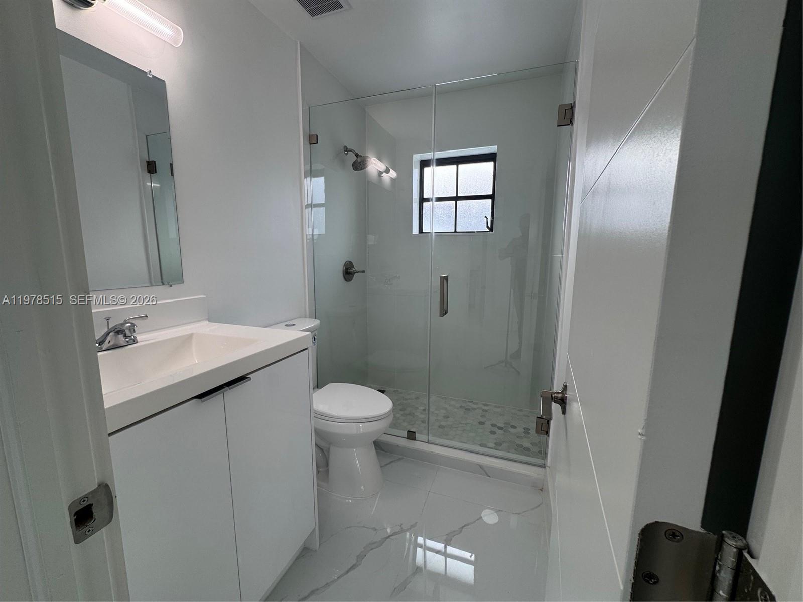 2682 West 70th Place Hialeah, FL 33016 - Photo 14 of 16 a bathroom with a granite countertop sink toilet and shower