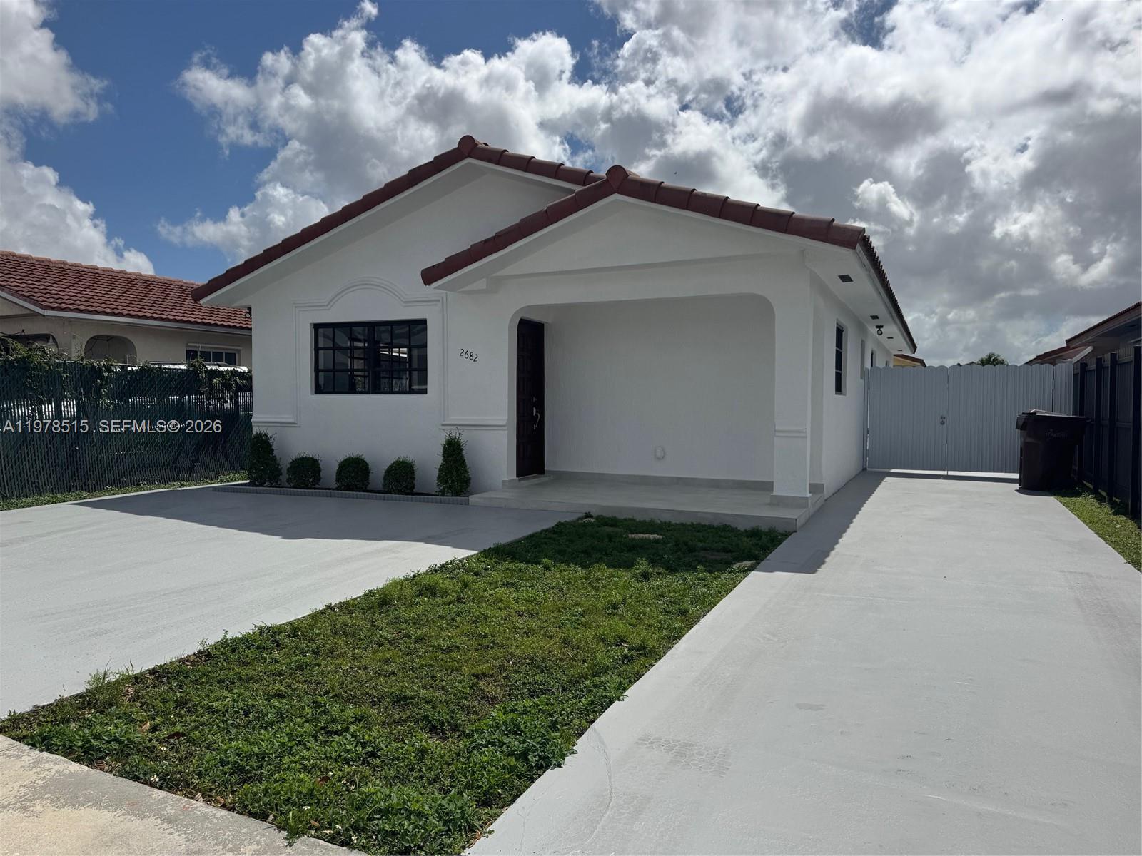 2682 West 70th Place Hialeah, FL 33016 - Photo 2 of 16 a front view of a house with a yard