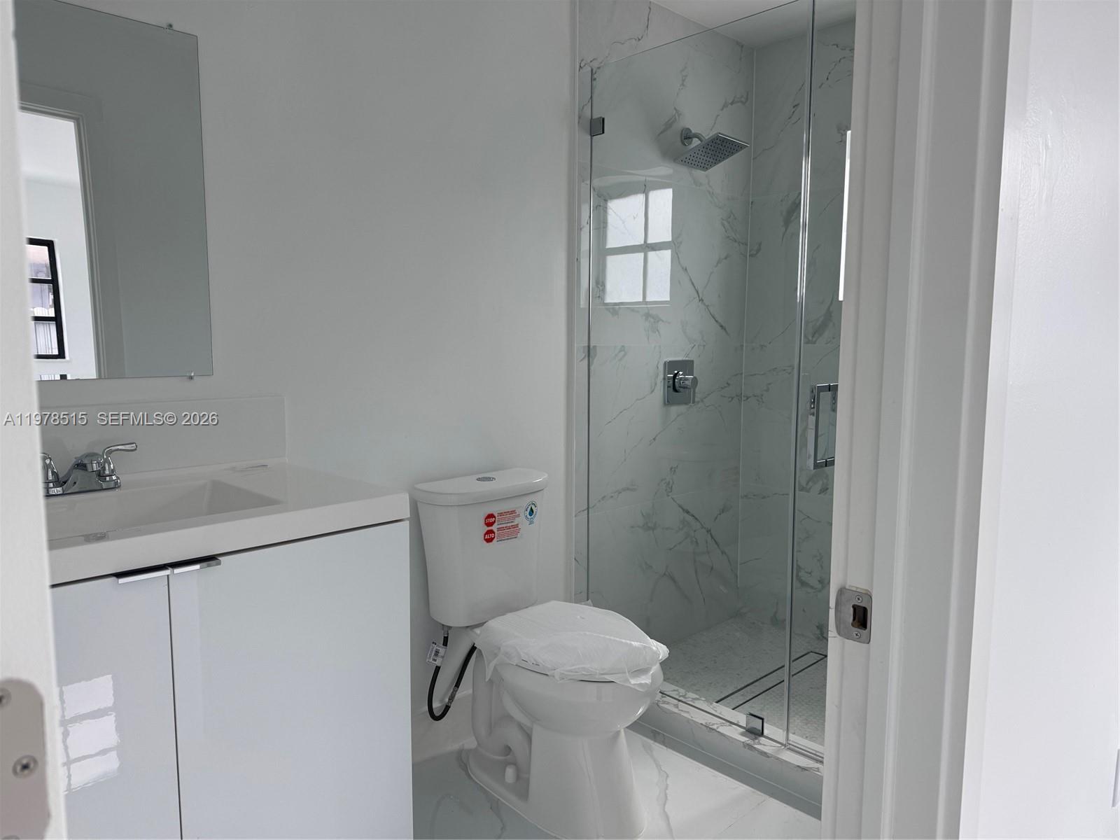 2682 West 70th Place Hialeah, FL 33016 - Photo 7 of 16 a bathroom with a shower toilet and sink