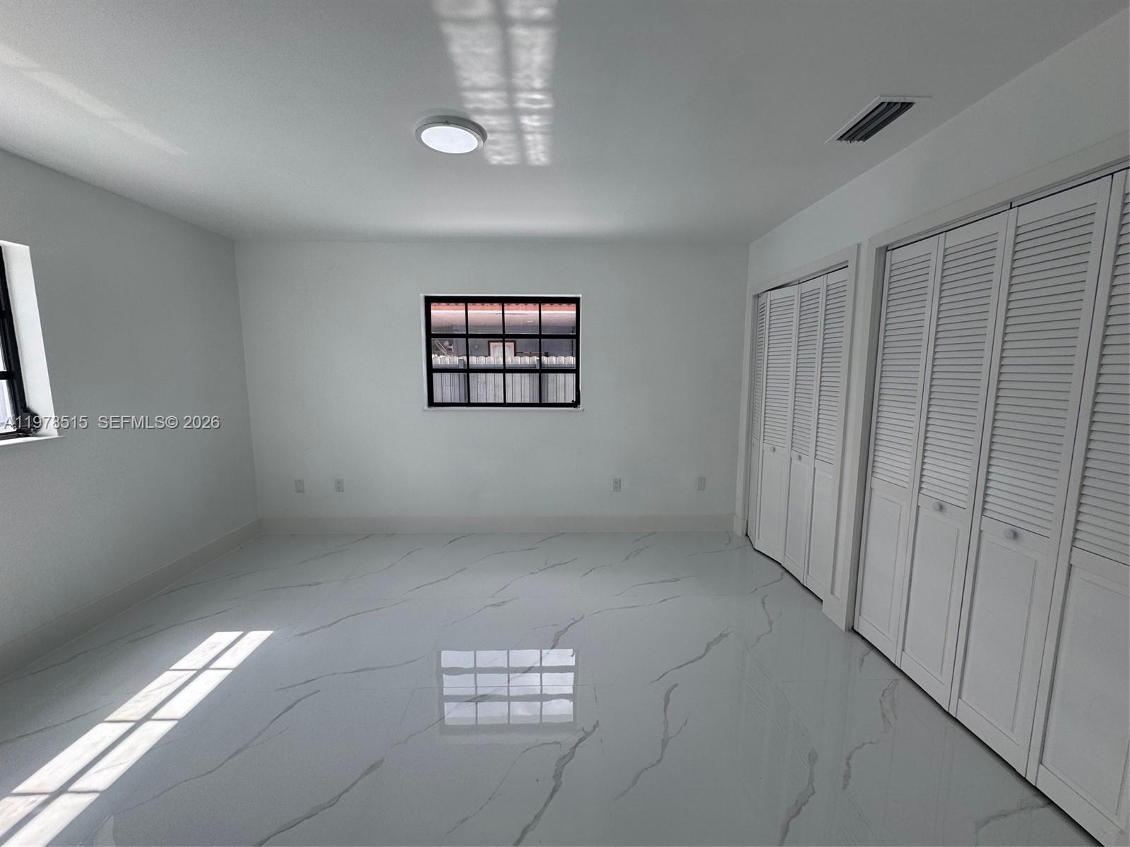 2682 West 70th Place Hialeah, FL 33016 - Photo 9 of 16 a view of an empty room with a window