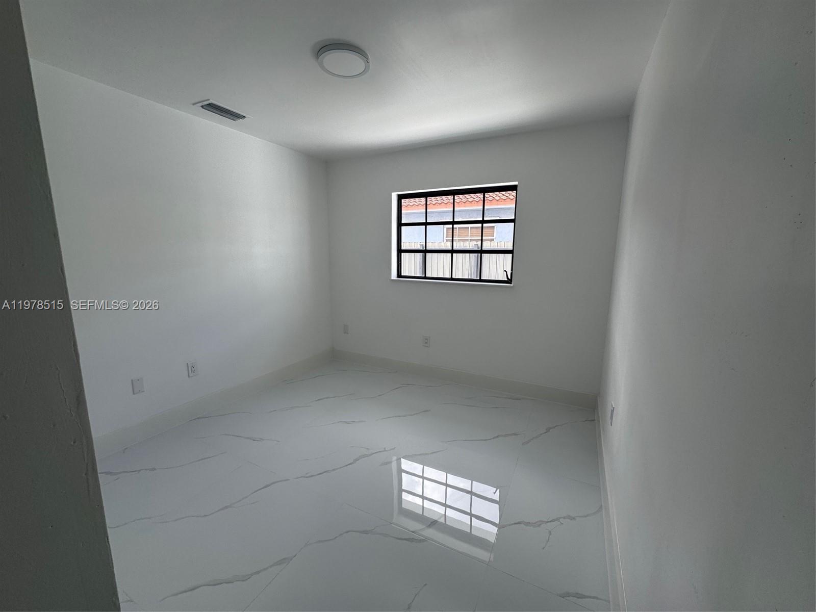 2682 West 70th Place Hialeah, FL 33016 - Photo 10 of 16 an empty room with windows