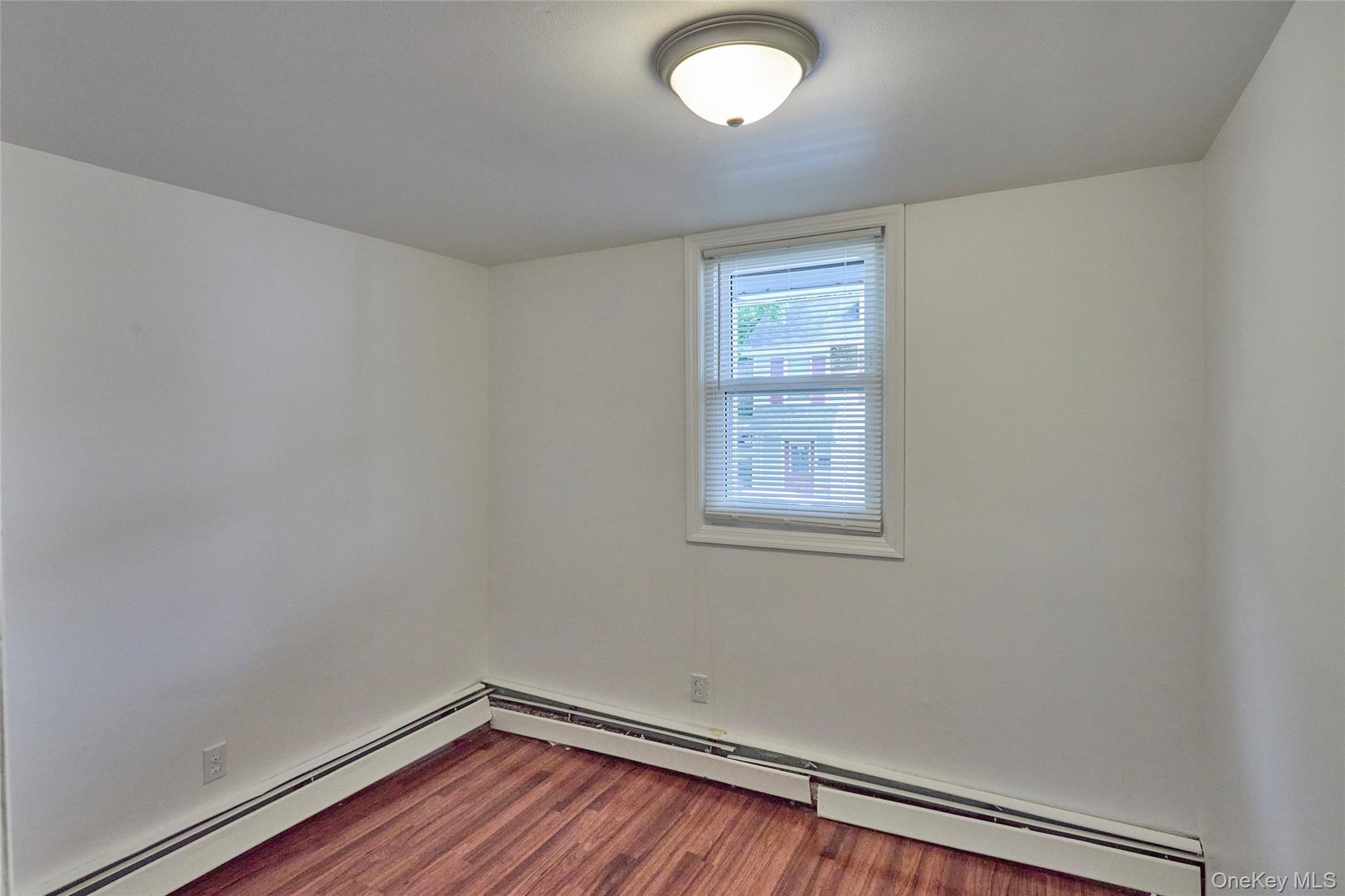 208 North James Street Peekskill, NY 10566 - Photo 6 of 13 2nd bedroom with laminate floor (Unit 1)