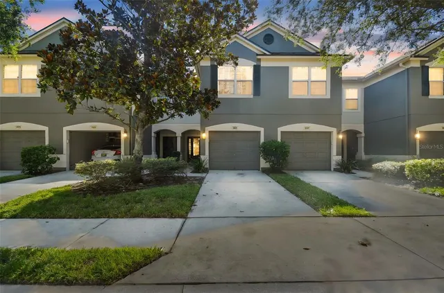a front view of a house with a yard and a garage