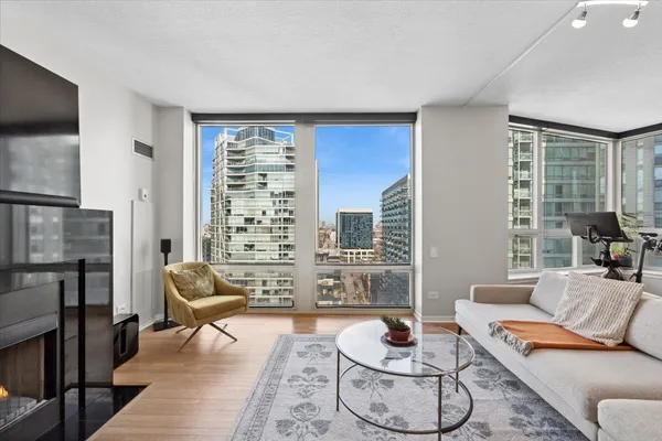 a living room with furniture a rug and a large window
