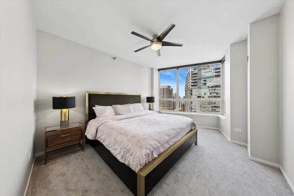 a bedroom with a bed and a lamp