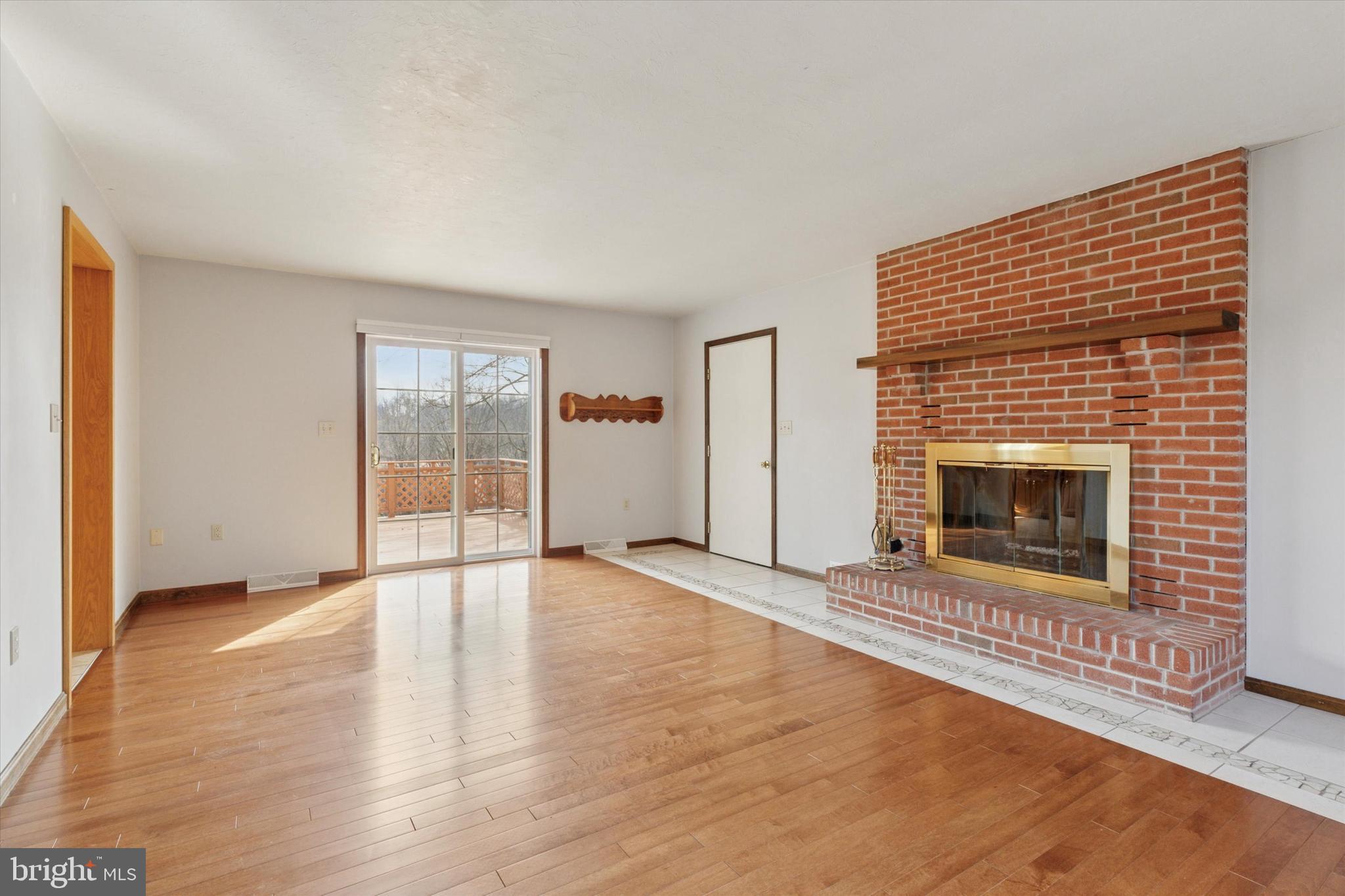 82 Starr Road Reading, PA 19608 - Photo 14 of 56 a view of an empty room with a fireplace and a window
