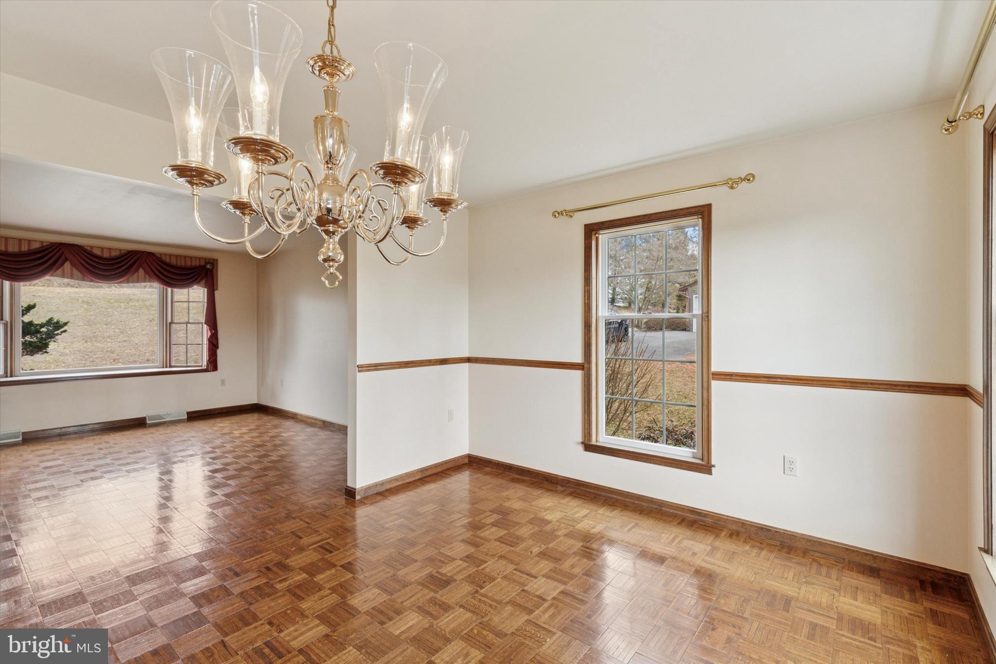 82 Starr Road Reading, PA 19608 - Photo 9 of 56 a view of an empty room with chandelier fan and wooden floor
