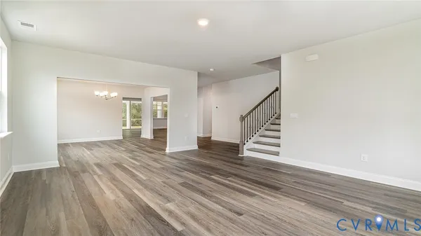 a view of a room with wooden floor and staircase